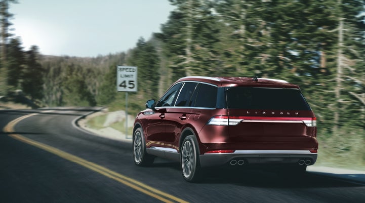 A 2024 Lincoln Aviator® SUV is being driven on a winding mountain road | Koons Lincoln of Bethesda in Silver Spring MD