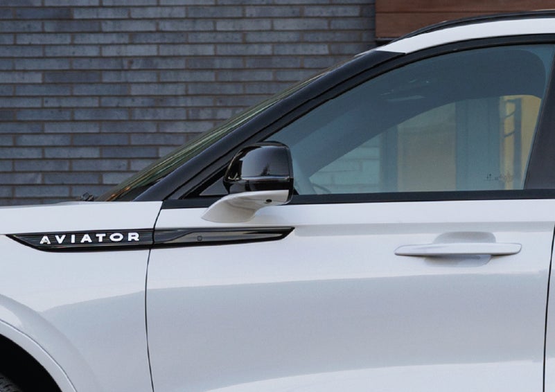 The driver’s side door and fender badging of a white 2026 Lincoln Aviator® SUV are showcased. | Koons Lincoln of Bethesda in Silver Spring MD