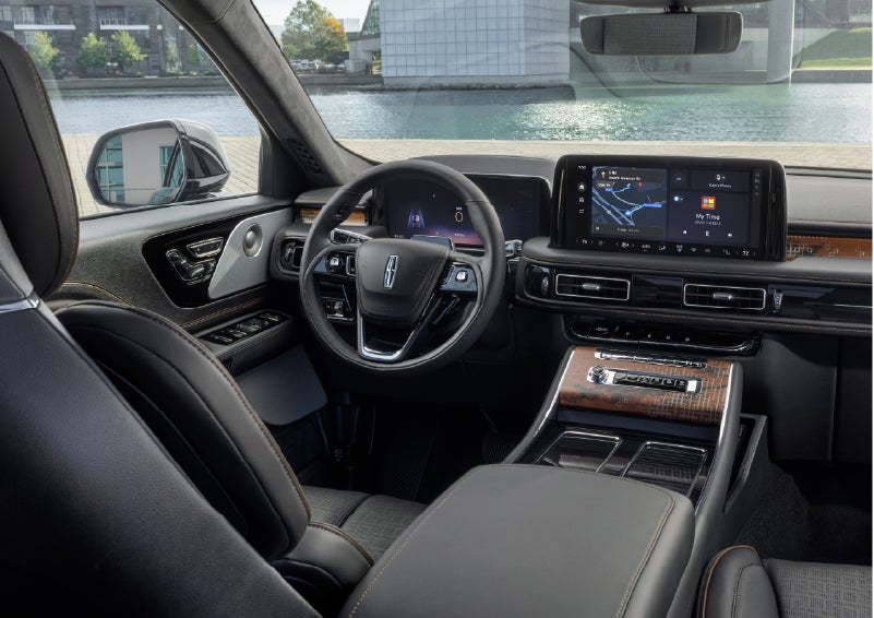 The interior of the 2026 Lincoln Aviator® SUV is shown parked with a view of a harbor through the windshield. | Koons Lincoln of Bethesda in Silver Spring MD