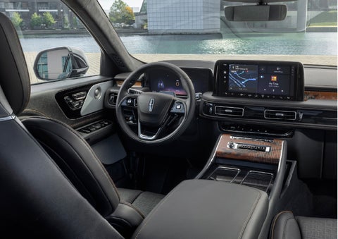 The interior of the 2026 Lincoln Aviator® SUV is shown parked with a view of a harbor through the windshield. | Koons Lincoln of Bethesda in Silver Spring MD