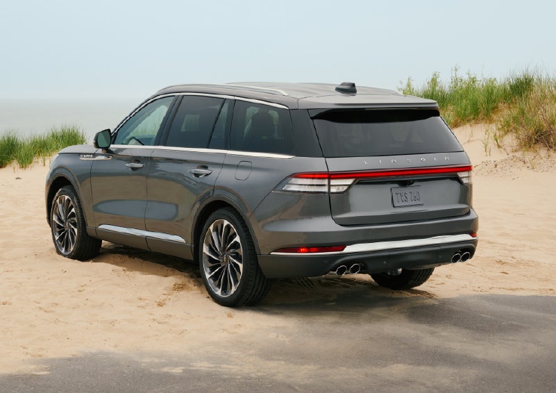 A 2027 Lincoln Aviator® SUV is parked next to sand dunes. | Koons Lincoln of Bethesda in Silver Spring MD
