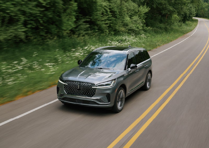 A 2027 Lincoln Aviator® SUV is being driven down a road. | Koons Lincoln of Bethesda in Silver Spring MD