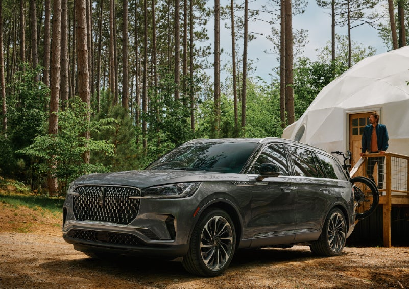 A 2027 Lincoln Aviator® is parked next to a high end glamping site. | Koons Lincoln of Bethesda in Silver Spring MD