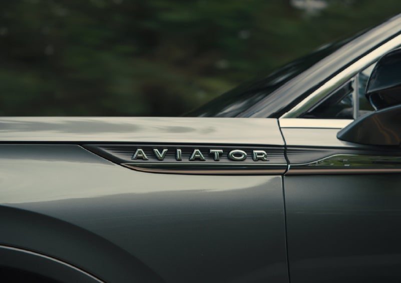 The driver’s side door and fender badging of a gray 2027 Lincoln Aviator® SUV are showcased. | Koons Lincoln of Bethesda in Silver Spring MD