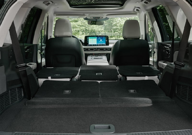 A rear to front view of the interior of a 2027 Lincoln Aviator® Black Label™ SUV shows the third and second rows folded flat | Koons Lincoln of Bethesda in Silver Spring MD