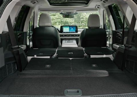 A rear to front view of the interior of a 2027 Lincoln Aviator® Black Label™ SUV shows the third and second rows folded flat | Koons Lincoln of Bethesda in Silver Spring MD