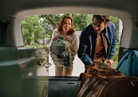 A couple loads luggage into the rear of a 2027 Lincoln Aviator® Black Label™ SUV..e 202 | Koons Lincoln of Bethesda in Silver Spring MD